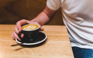 holding cup of Coffee